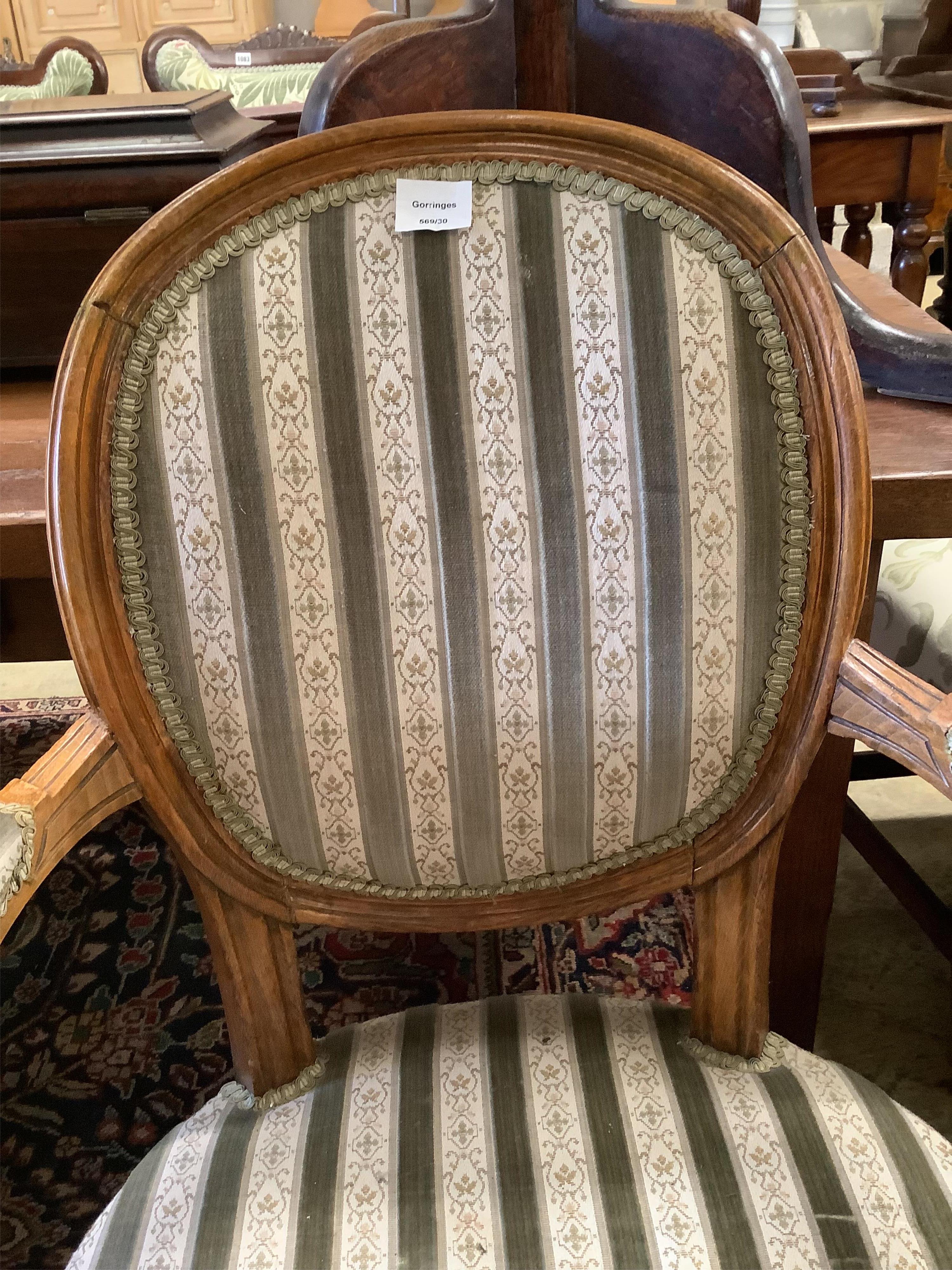 A Louis XVI design upholstered open armchair